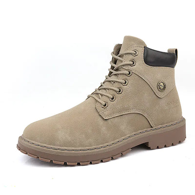 Beige boot with black heel tab on a white background