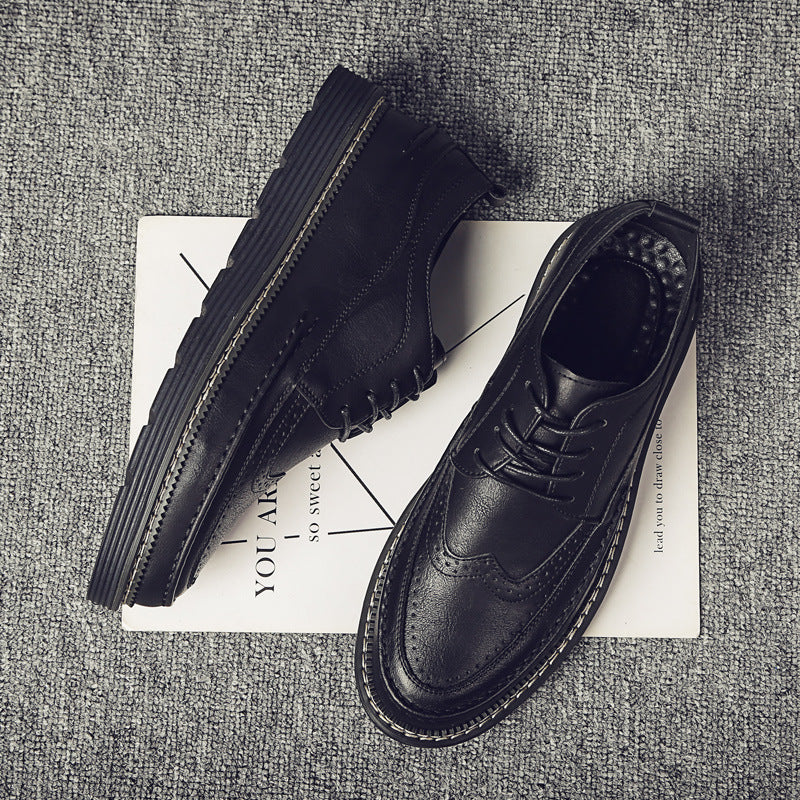 Black leather shoes on a textured surface with a magazine underneath