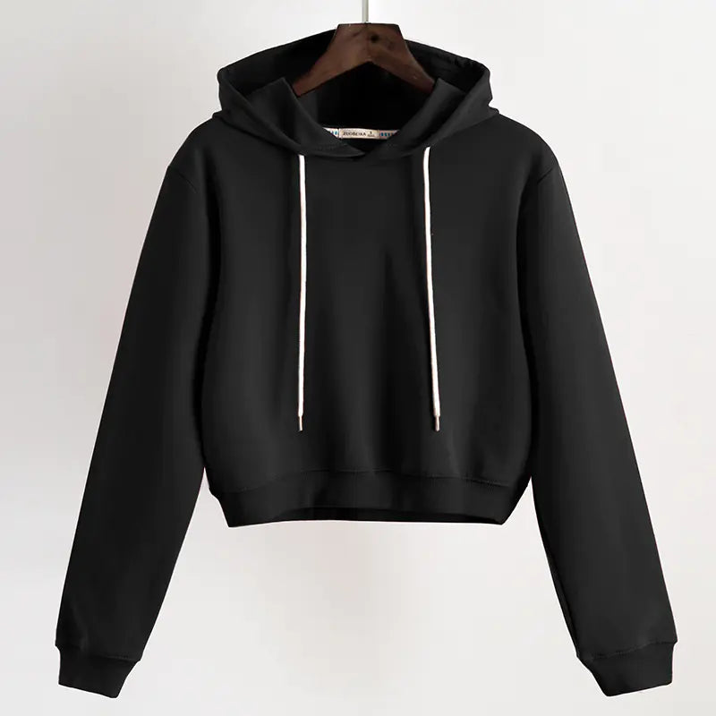 Black hoodie on a hanger against a white background