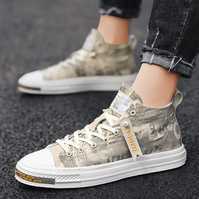 Gray high-top sneakers with white soles worn by a person on a dark surface