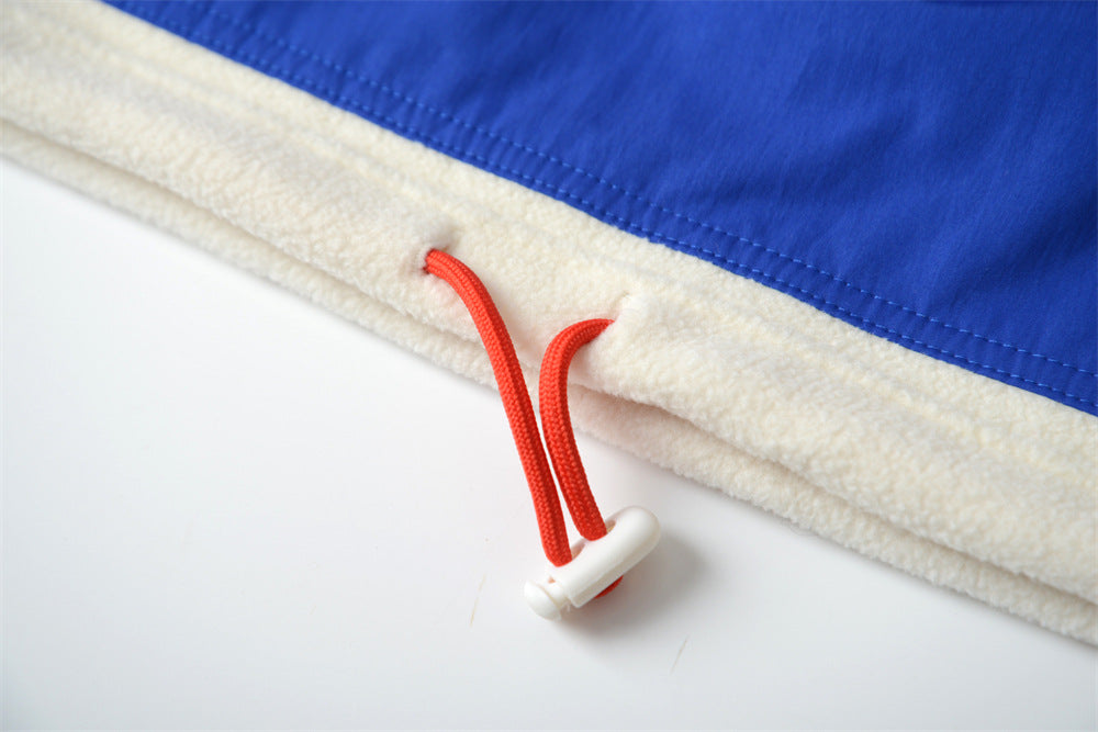 Close-up of a blue and beige fabric with red elastic band and white buttons on a white background