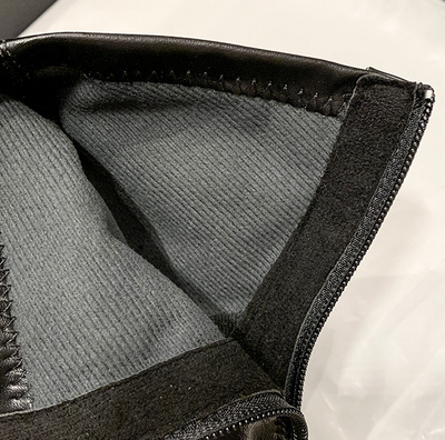 Close-up of a textured fabric interior with black trim