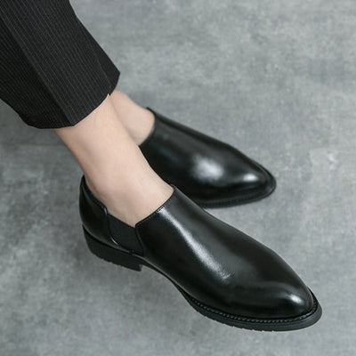 Black leather shoes worn with a gray background
