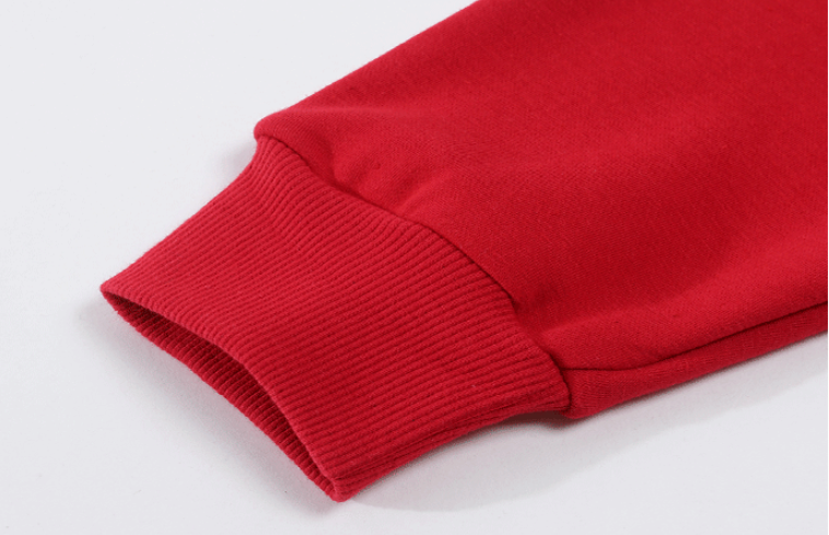 Close-up of a red sweatshirt sleeve on a light gray background