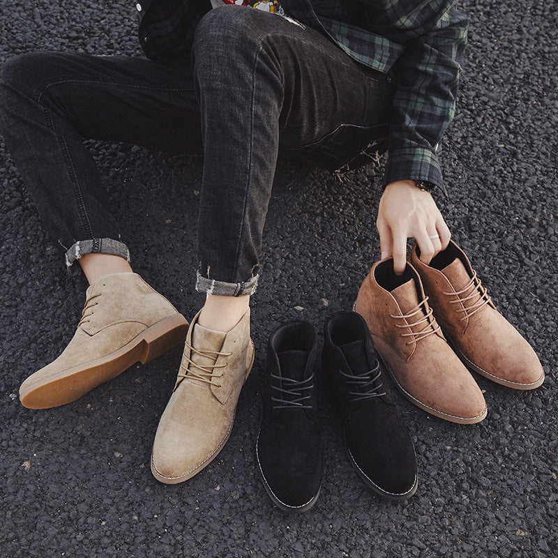 Person wearing tan and black boots on a dark surface