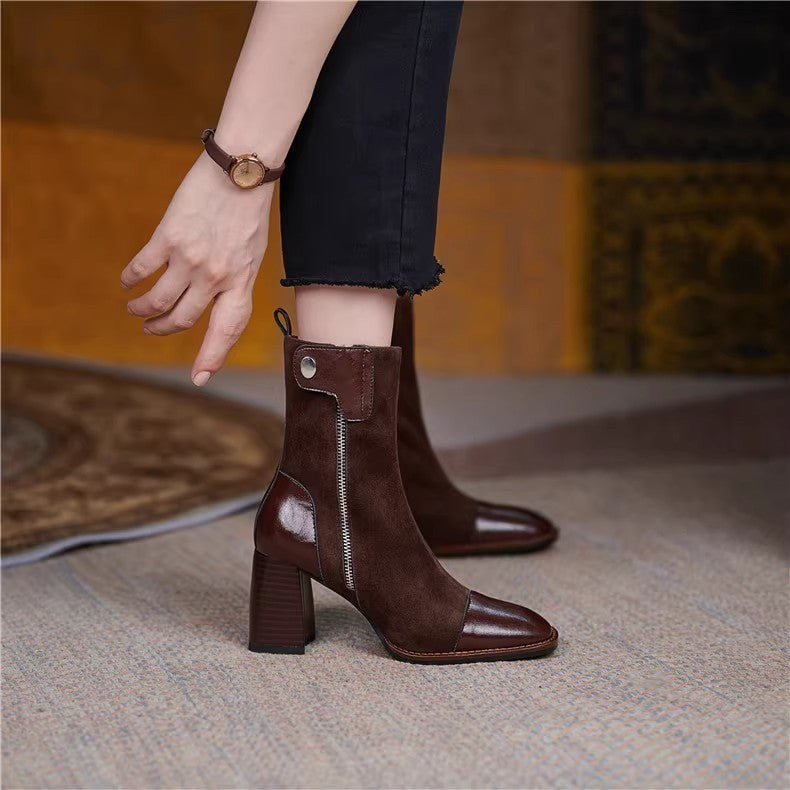 Brown ankle boots worn by a person on a textured surface with a blurred background