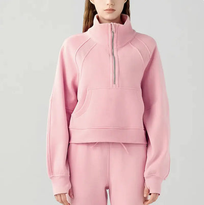 Pink tracksuit worn by a person on a light gray background