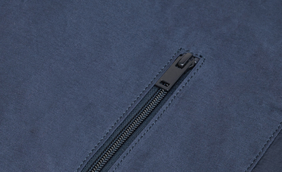 Close-up of a zipper on a blue fabric background