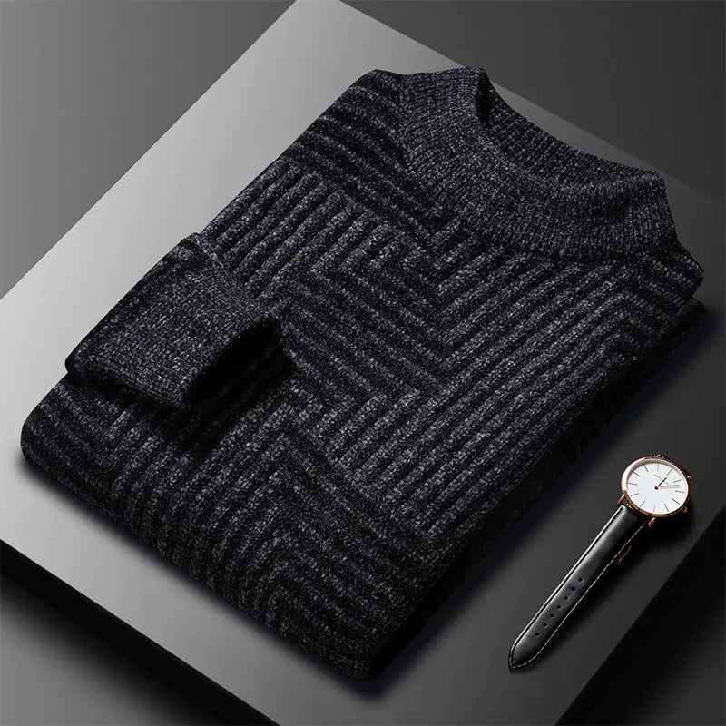 Dark gray textured sweater on a reflective surface with a watch next to it