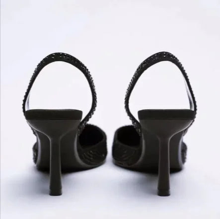 Black high-heeled shoes on a white background