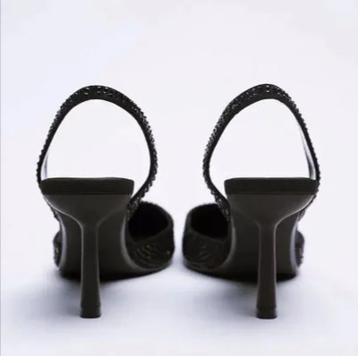 Black high-heeled shoes on a white background