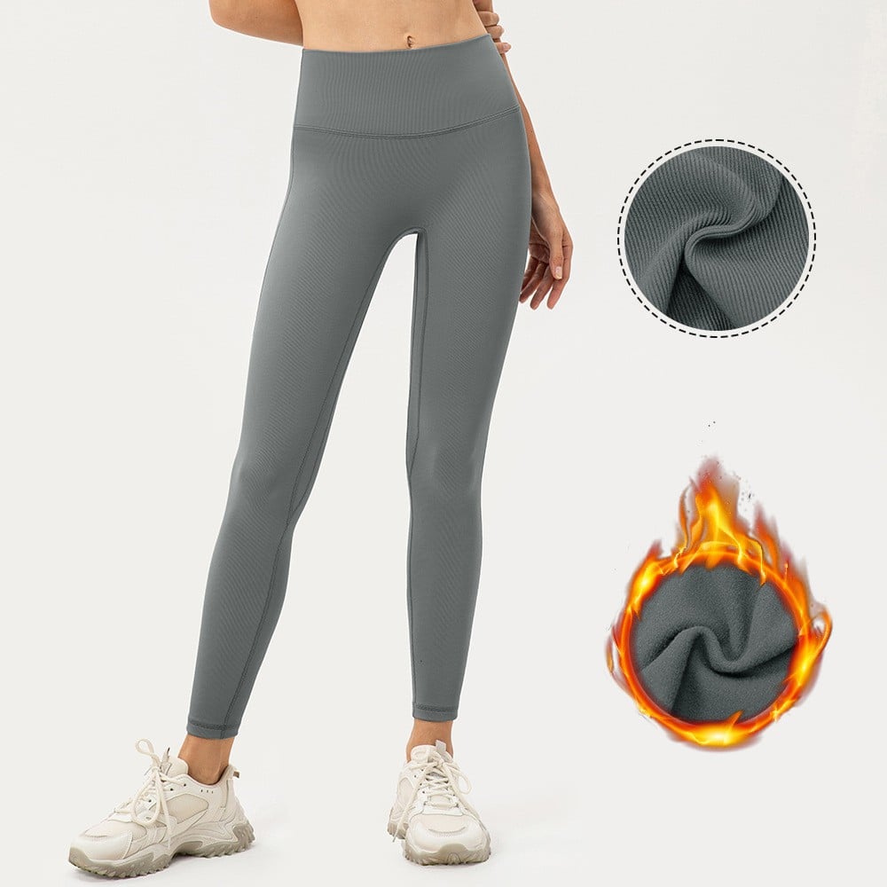 Gray leggings with a close-up of fabric texture and flame graphic on a white background