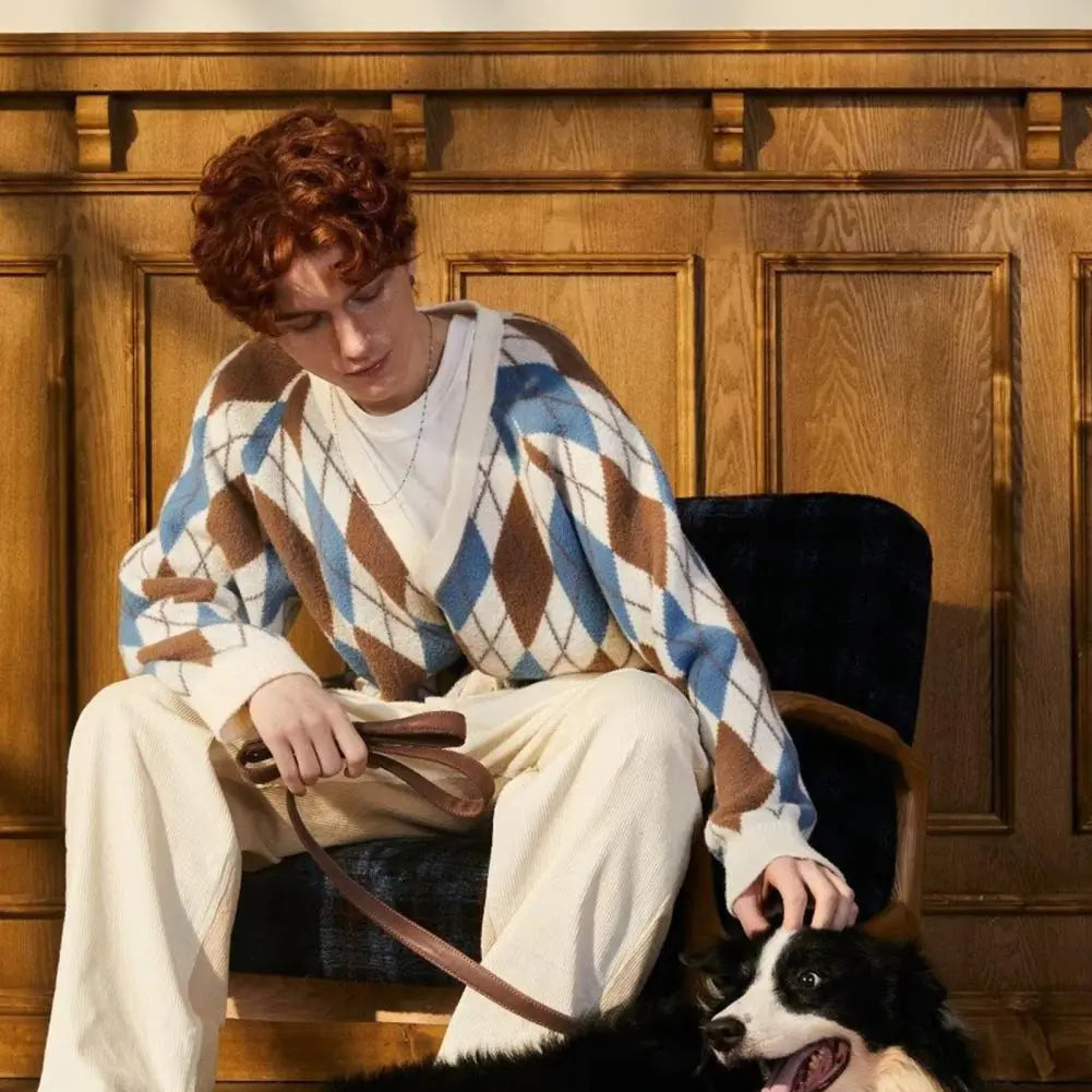 Person sitting with a dog on a chair against a wooden paneled wall