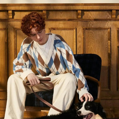 Person sitting with a dog on a chair against a wooden paneled wall