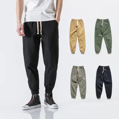 Black jogger pants with four additional color options displayed on a white background.