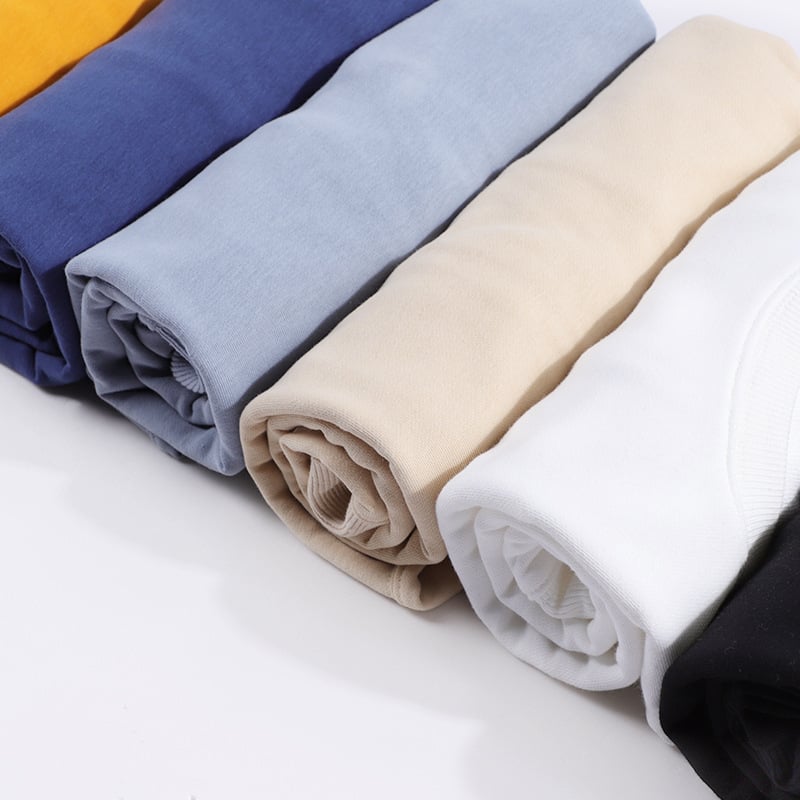 close-up Stack of folded fabric in various colors on a white surface