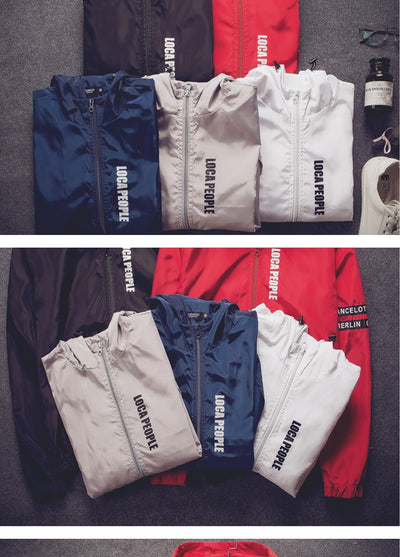 Folded jackets in blue, white, and red with 'LOCA PEOPLE' branding on a gray surface.