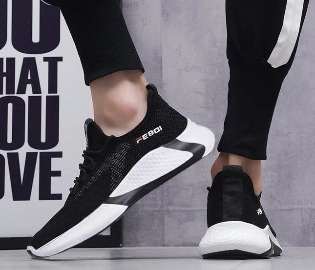 Black and white running shoes with 'FEBO' branding on a gray background