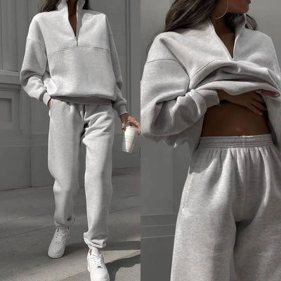 Gray tracksuit worn by a person with a neutral background