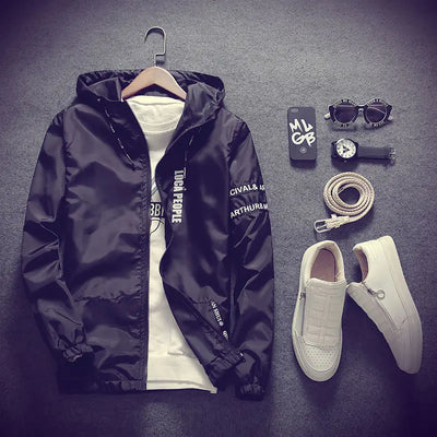 Black jacket, white sneakers, and accessories on a dark gray background