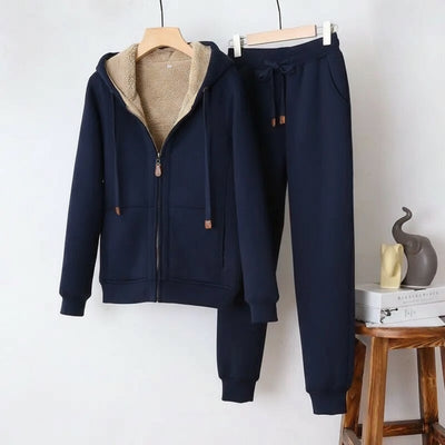 Navy blue tracksuit with beige fleece lining on a white background