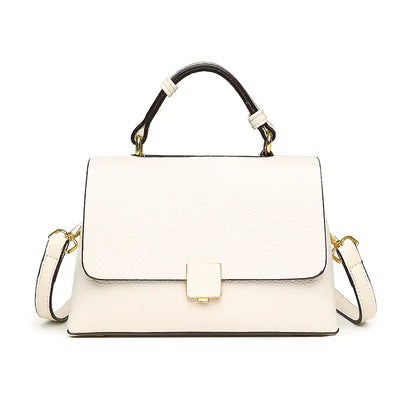 White handbag with black handle and gold accents on a white background