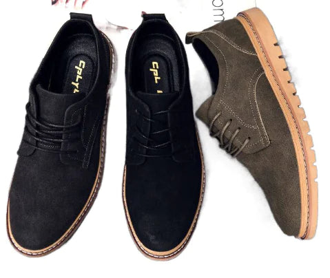 Black suede shoes and a brown leather shoe on a white background