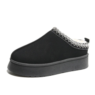 Black slipper with decorative trim on a white background