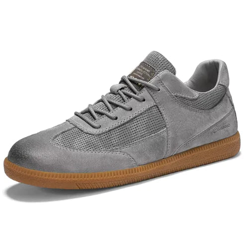 Gray sneaker with brown sole on a white background
