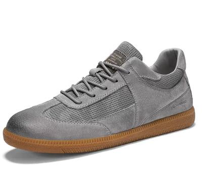Gray sneaker with brown sole on a white background