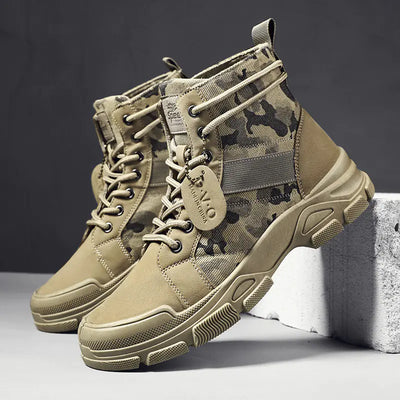 Tan camouflage tactical boots on a gray background