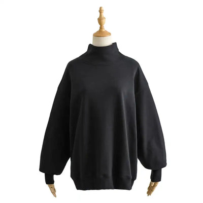 Black turtleneck sweater on a mannequin against a white background