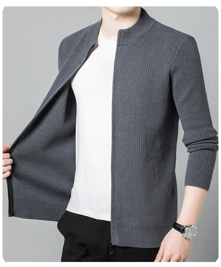 Gray knitted cardigan over a white shirt on a gray background