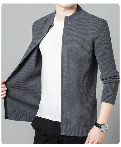 Gray knitted cardigan over a white shirt on a gray background