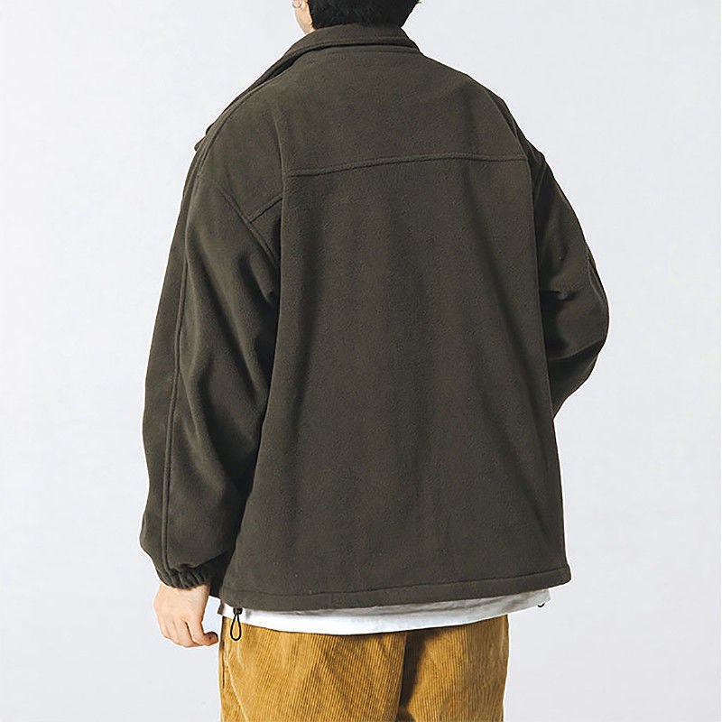 Person wearing a dark green jacket on a white background