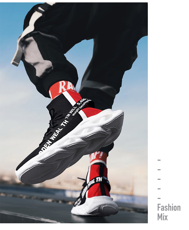 Person wearing black, red, and white sneakers with text design, jumping on a blurred background.