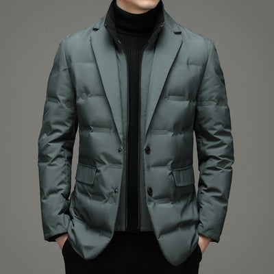 Green puffer jacket worn by a person on a gray background