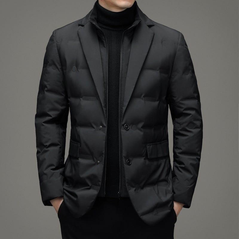Black puffer jacket worn by a person on a gray background