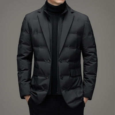 Black puffer jacket worn by a person on a gray background