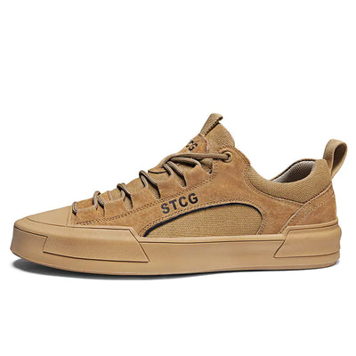 Tan sneaker with 'STCG' branding on a white background
