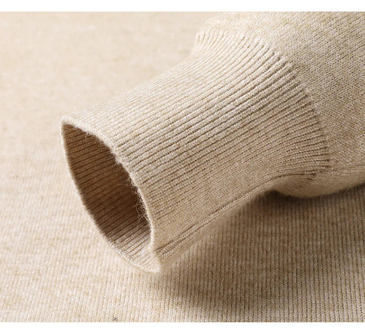 Close-up of beige knit fabric with a focus on texture and color.