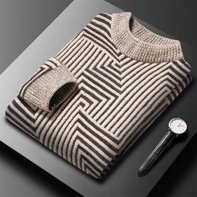 Folded striped sweater with a watch on a dark surface