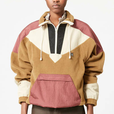Person wearing a colorful pullover with a geometric pattern on a white background