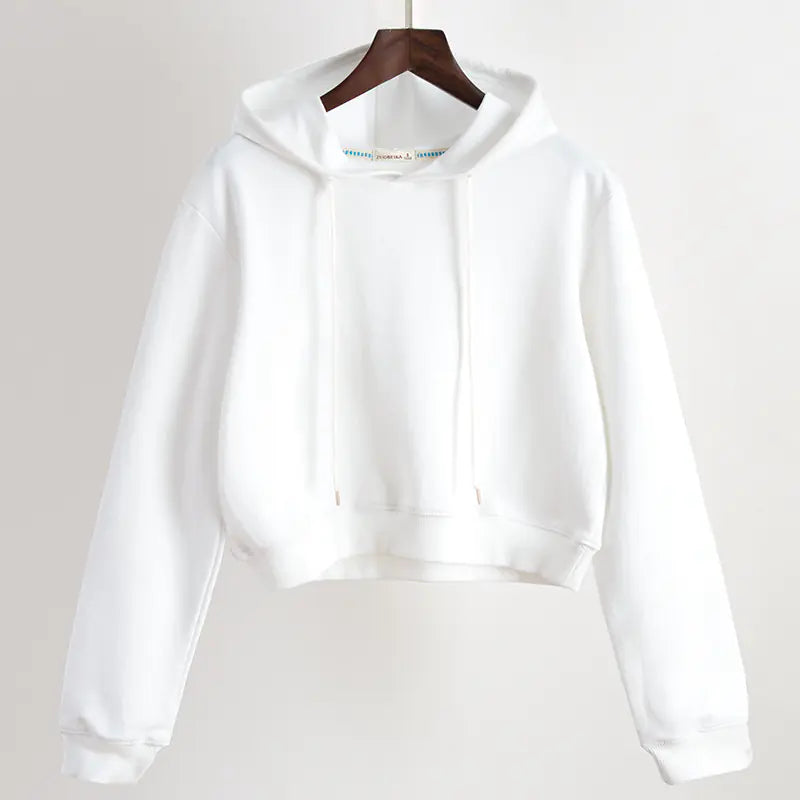 White hoodie on a hanger against a plain background