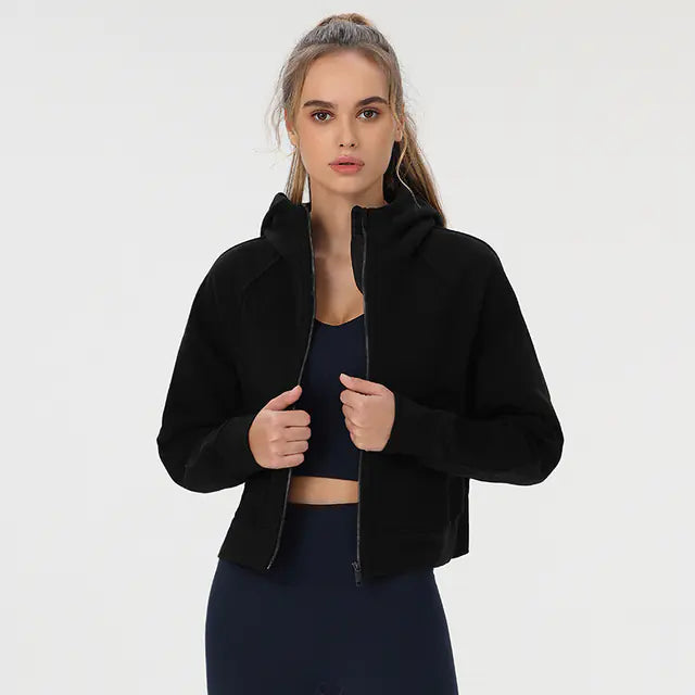 Woman wearing a black jacket over a dark top on a white background