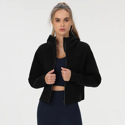 Woman wearing a black jacket over a dark top on a white background