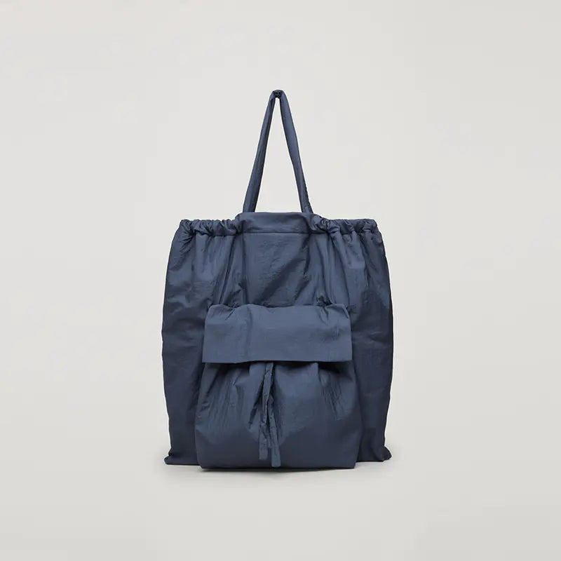 Blue drawstring bag on a light gray background