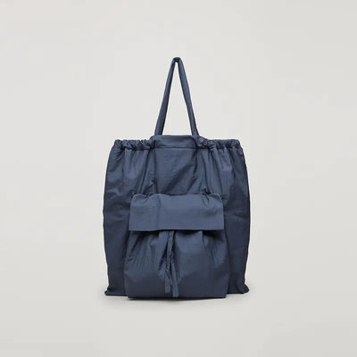 Blue drawstring bag on a light gray background