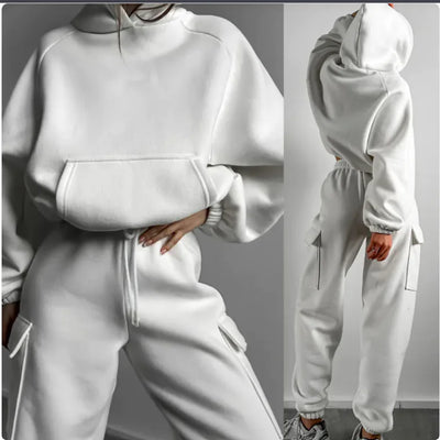 White tracksuit worn by a person on a gray background