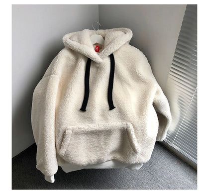 White fleece hoodie with black drawstrings on a hanger against a neutral wall.